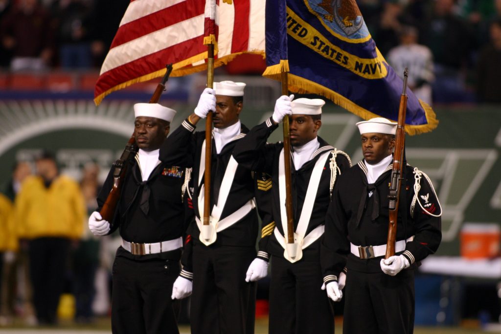 041101-N-0000X-001 East Rutherford, N.J. (Nov. 1, 2004) Ð A U.S. Navy color guard assigned to Naval Reserve Center Bronx, New York, parade the colors during the opening ceremony for Monday NightÕs Football game between the New York Jets and Miami Dolphins, at the Meadowlands Sports Complex. From left, MachinistÕs Mate 1st Class Jason Maynard, Operations Specialist 1st Class Michael Allen, Personnelman Seaman Apprentice Michael A. Cowan and Aviation ElectricianÕs Mate 2nd Class Darris Dupree, Jr. U.S. Navy photo by Alexander H. Craver, III (RELEASED)